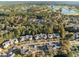 An aerial view captures condo buildings with parking areas in a neighborhood close to a lush golf course and pond at 4818 Innisbrook Ct. # 603, Myrtle Beach, SC 29579