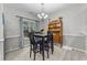 Dining room with a modern light fixture, sleek black table, and built-in display cabinet, ideal for entertaining at 4818 Innisbrook Ct. # 603, Myrtle Beach, SC 29579