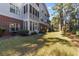 Charming condo exterior featuring a screened porch, and a well-maintained lawn area surrounded by trees at 4818 Innisbrook Ct. # 603, Myrtle Beach, SC 29579