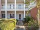 Inviting condo entrance with manicured bushes, brick accents, and a covered balcony, showcasing curb appeal at 4818 Innisbrook Ct. # 603, Myrtle Beach, SC 29579