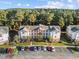 The building's exterior view features balconies, parking spaces, and a well-kept lawn area with trees at 4818 Innisbrook Ct. # 603, Myrtle Beach, SC 29579