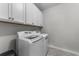 A compact laundry room featuring modern, front-loading washer and dryer with storage cabinets above at 4818 Innisbrook Ct. # 603, Myrtle Beach, SC 29579