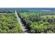 Aerial view of a road lined with lush trees and natural landscaping at 604 Mccown Dr., Conway, SC 29526