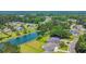 Aerial view of a neighborhood featuring a pond surrounded by lush landscaping and beautiful homes at 604 Mccown Dr., Conway, SC 29526
