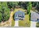 Aerial view of a well-maintained home with green lawn, mature trees, and a paved driveway at 604 Mccown Dr., Conway, SC 29526