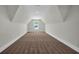 Unfinished attic space carpeted in a neutral tone and a single window looking out at 604 Mccown Dr., Conway, SC 29526