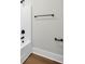 Minimalist bathroom with white tub, black fixtures, and modern towel bars at 604 Mccown Dr., Conway, SC 29526