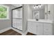 Bathroom with glass shower, vinyl flooring, white vanity, and three-bulb vanity lighting at 604 Mccown Dr., Conway, SC 29526