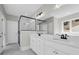 Bright bathroom featuring a double vanity, marble countertops, and a glass-enclosed shower with black trim at 604 Mccown Dr., Conway, SC 29526