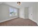 Bedroom with neutral walls, brown carpet, white trim and doors, plus a large window for natural light at 604 Mccown Dr., Conway, SC 29526