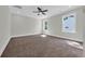 Spacious bedroom with neutral carpet, two windows offering natural light, and a ceiling fan at 604 Mccown Dr., Conway, SC 29526