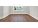 Bedroom with luxury vinyl floors and a large window to the home next door at 604 Mccown Dr., Conway, SC 29526