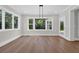 Bright dining area featuring hardwood floors, a modern chandelier, and a large window with natural light at 604 Mccown Dr., Conway, SC 29526
