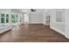 Living room with luxury vinyl flooring, ceiling fan, and sliding glass doors to screened porch at 604 Mccown Dr., Conway, SC 29526
