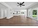 Open-concept living room with wood floors, plenty of natural light, and views into the kitchen at 604 Mccown Dr., Conway, SC 29526