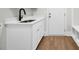 Mudroom with sink, white cabinets, and an exterior door to the backyard at 604 Mccown Dr., Conway, SC 29526