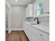 Mudroom with counter space, storage cabinets, a utility sink, and a view to the backyard at 604 Mccown Dr., Conway, SC 29526