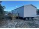 Rear view of gray mobile home with wooden deck and steps at 1412 Seagull Blvd., North Myrtle Beach, SC 29582