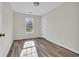This bedroom is painted in a neutral color, has wood-look flooring and a window for natural light at 1960 Hampton St., Georgetown, SC 29440