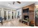Cozy living room featuring a brick fireplace, an open layout, and a view of the dining area at 1969 Governors Landing Rd. # 224, Murrells Inlet, SC 29576