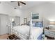 Charming main bedroom with a four poster bed, sitting area and a ceiling fan at 1969 Governors Landing Rd. # 224, Murrells Inlet, SC 29576