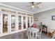 Relaxing porch area with a round table, chairs, and views through glass doors to the living room at 1969 Governors Landing Rd. # 224, Murrells Inlet, SC 29576