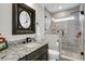 Modern bathroom showcasing a sleek vanity with a black faucet and a glass-enclosed shower with elegant tiling at 253 W Second Ave. S, Ocean Isle Beach, NC 28469