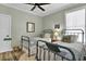 Charming bedroom featuring two twin beds with blue frames, complemented by beach-themed decor and a ceiling fan at 253 W Second Ave. S, Ocean Isle Beach, NC 28469