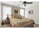 Inviting bedroom with a large bed, decorative quilt, soft lighting, and a ceiling fan for added comfort at 253 W Second Ave. S, Ocean Isle Beach, NC 28469