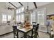 Bright dining area features a decorative table setting, chandelier, and multiple windows for natural light at 253 W Second Ave. S, Ocean Isle Beach, NC 28469