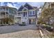 Home featuring a garage and ample parking, a charming front porch, and a well maintained landscape at 253 W Second Ave. S, Ocean Isle Beach, NC 28469
