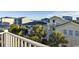 Coastal home with palm trees, multiple balconies, and views of the neighborhood and ocean at 253 W Second Ave. S, Ocean Isle Beach, NC 28469