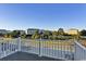 Balcony view of beach homes and condo buildings with palm trees and grassy areas at 253 W Second Ave. S, Ocean Isle Beach, NC 28469