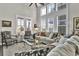 Inviting living room with high ceilings, large windows, comfortable seating, and natural light throughout at 253 W Second Ave. S, Ocean Isle Beach, NC 28469