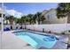 Backyard pool with lounge chairs, privacy fence, and palm trees in a beach community at 253 W Second Ave. S, Ocean Isle Beach, NC 28469