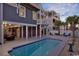 Backyard view of a private pool, outdoor dining, and lounge chairs on a sunny day at 253 W Second Ave. S, Ocean Isle Beach, NC 28469