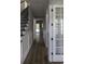 Inviting hallway features decorative wainscoting and hardwood floors, leading to various rooms and the staircase at 3057 Moss Bridge Ln., Myrtle Beach, SC 29579