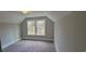 Cozy bedroom featuring natural light from double windows, carpeted floor, and calming neutral wall color at 681 Hawthorn Dr., Pawleys Island, SC 29585
