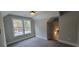 Comfortable bedroom with window offering views, soft carpet, and neutral paint, creating a relaxing space at 681 Hawthorn Dr., Pawleys Island, SC 29585