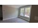 Bright bedroom with a window showcasing natural light, neutral walls, and plush carpeting, cozy and inviting at 681 Hawthorn Dr., Pawleys Island, SC 29585