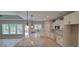 Well-lit kitchen with white cabinets, granite counters, stainless steel appliances, and a view through the windows at 681 Hawthorn Dr., Pawleys Island, SC 29585