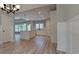 Bright kitchen features a central island, modern lighting, stainless steel sink, and a view of the backyard at 681 Hawthorn Dr., Pawleys Island, SC 29585