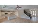 Open-concept living space with a kitchen island, modern lighting, and stairs with a barn door to upper level at 681 Hawthorn Dr., Pawleys Island, SC 29585