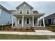 Charming two-story home featuring a welcoming front porch with classic white columns at 718 Macon Alley, Myrtle Beach, SC 29588