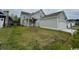 Home exterior view featuring a detached garage and a neatly maintained lawn at 718 Macon Alley, Myrtle Beach, SC 29588