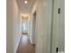 Long, brightly lit hallway with hardwood floors, leading to various rooms in the house at 718 Macon Alley, Myrtle Beach, SC 29588