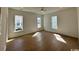 Well-lit living room with hardwood floors and large windows, offering ample natural light at 718 Macon Alley, Myrtle Beach, SC 29588