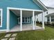 Inviting covered back porch with brick and neutral toned flooring, great for outdoor relaxation at 734 Macon Alley, Myrtle Beach, SC 29588