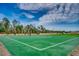 Community basketball court surrounded by a fence and trees, under a partly cloudy sky at 734 Macon Alley, Myrtle Beach, SC 29588