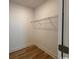 A compact closet space with a wire rack shelf and wood-style flooring at 734 Macon Alley, Myrtle Beach, SC 29588